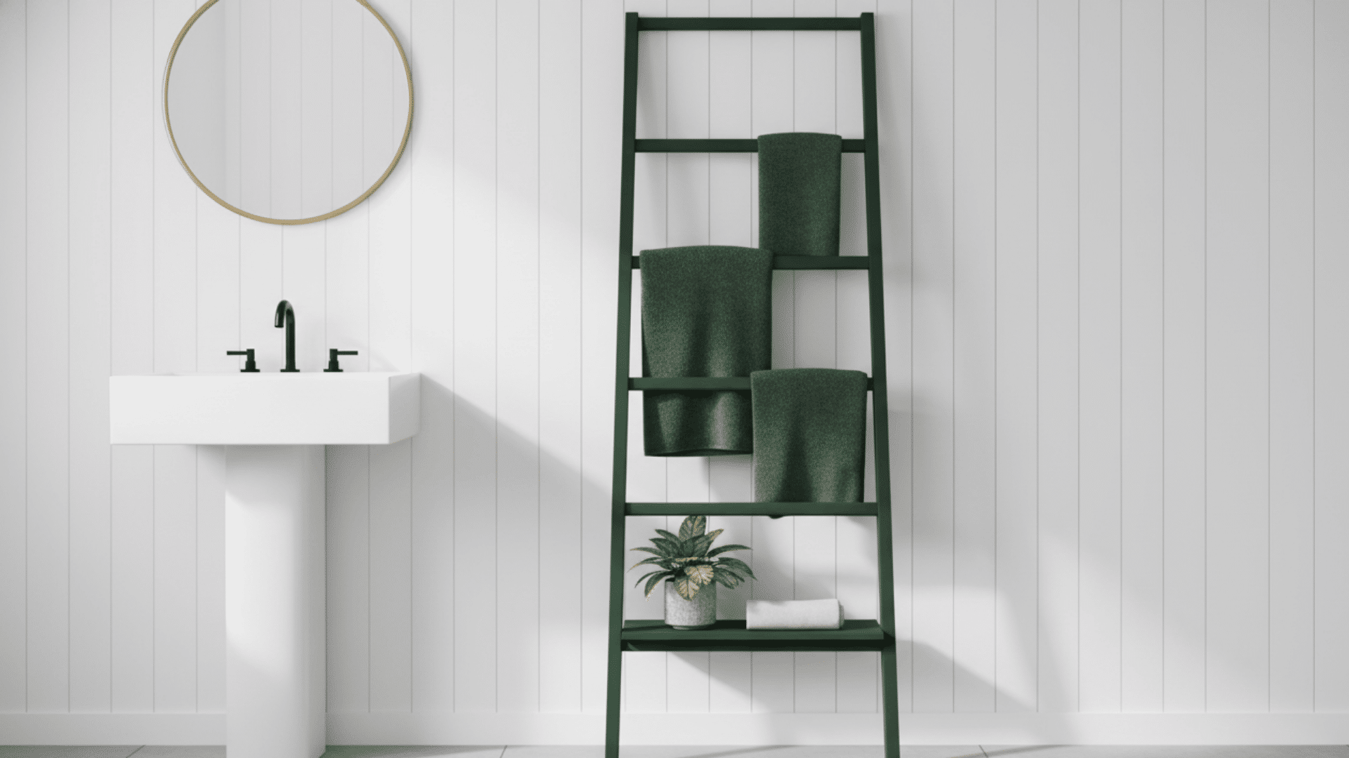 A dark green leaning storage ladder holding folded towels in a minimalist white bathroom.