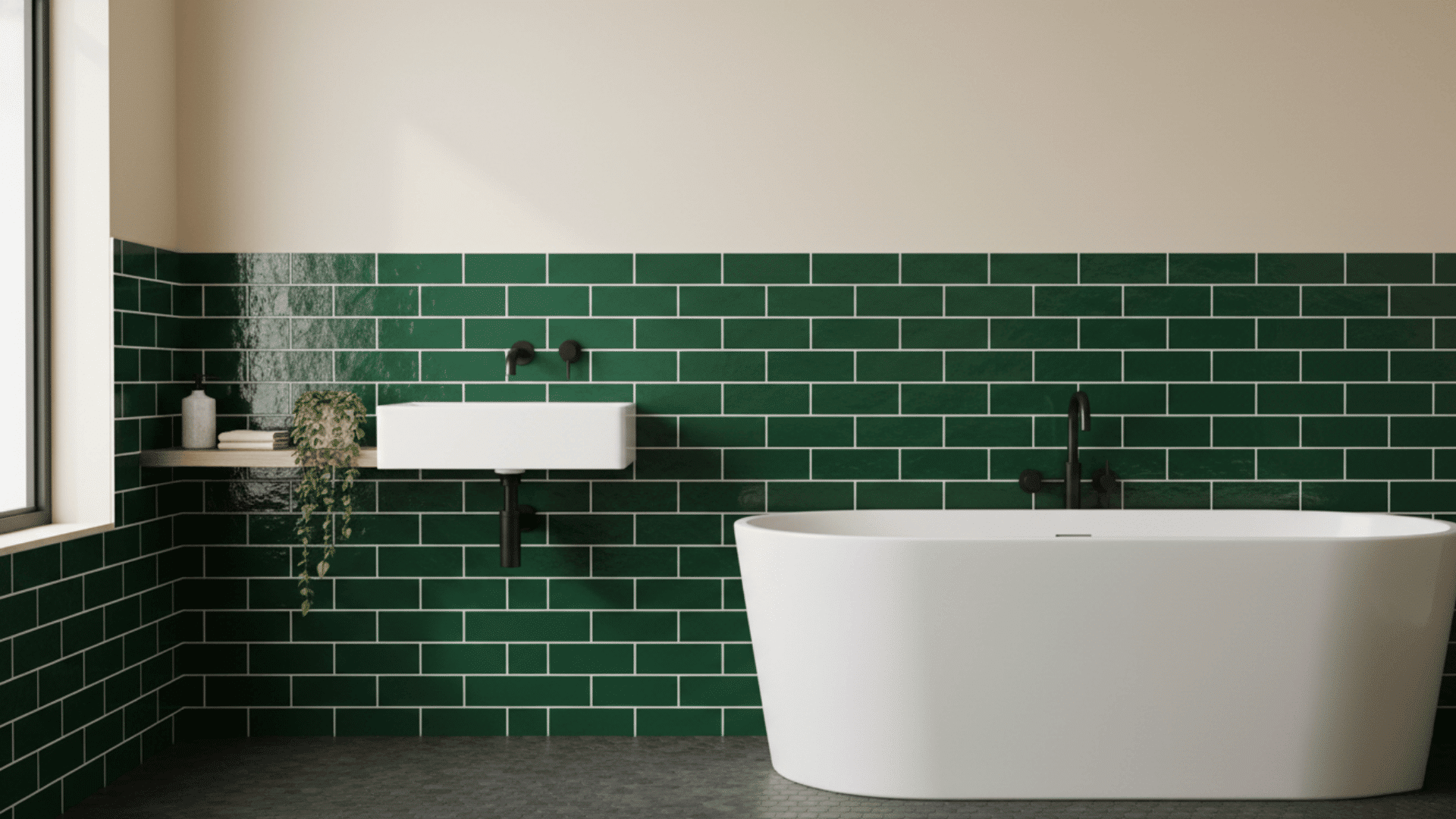Vertical dark green subway tile half-wall behind a white sink and freestanding bathtub.
