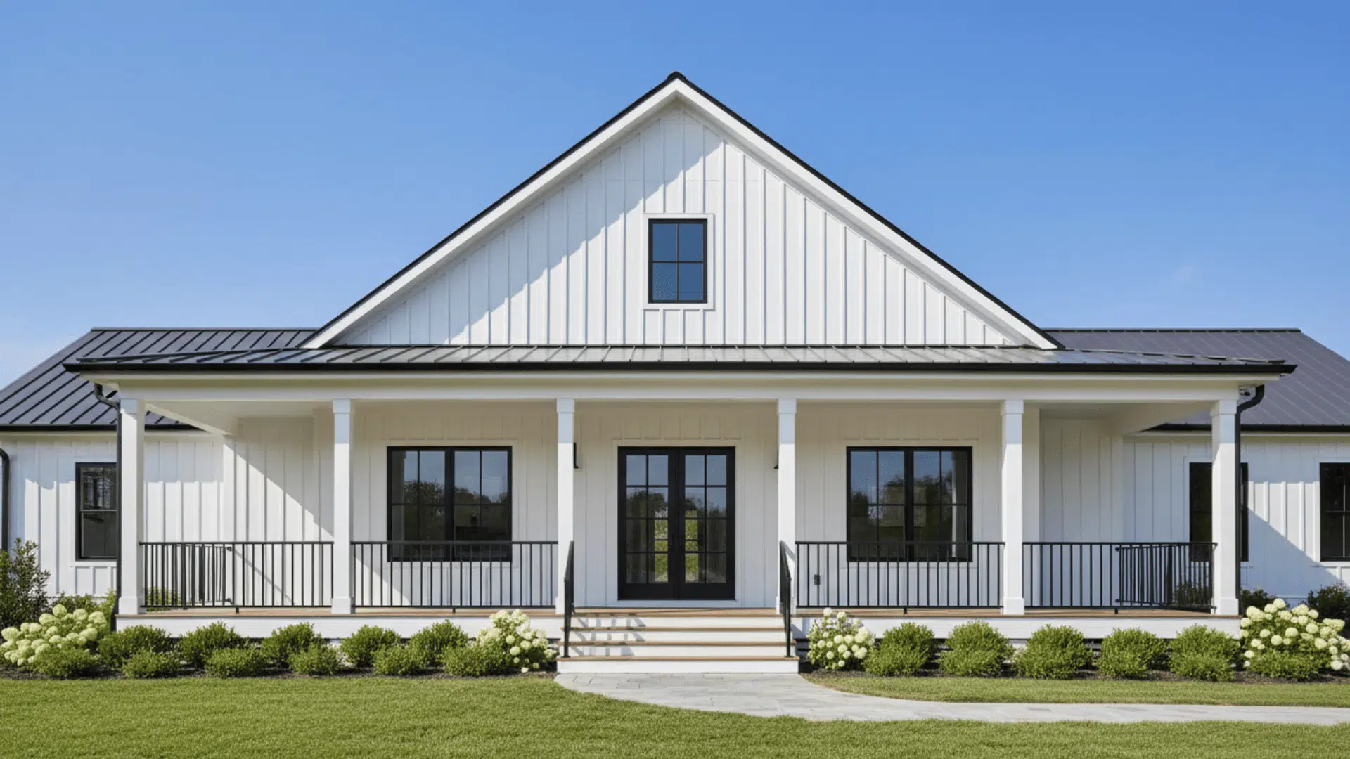White modern farmhouse exterior with black metal roof, board and batten siding, and wide front porch design