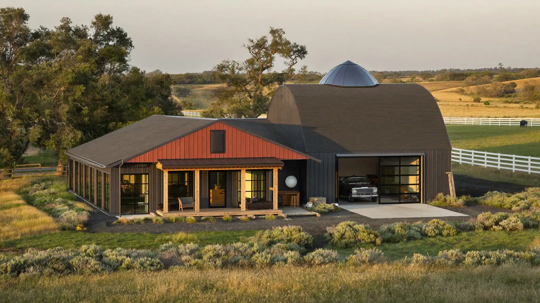 A large metal barndominium blending a residential living wing with a spacious workshop.