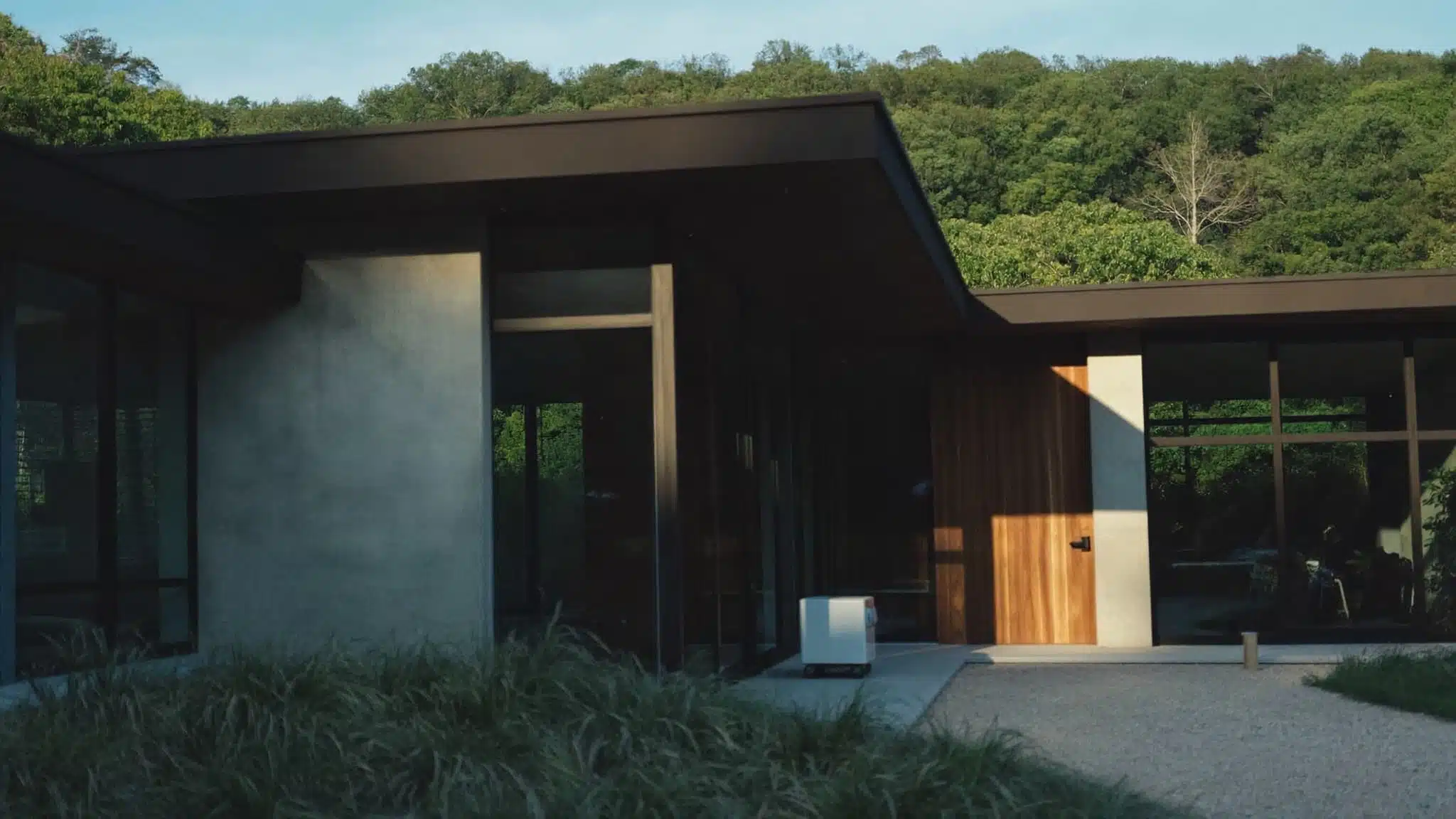 A sleek contemporary house with sharp geometric lines, flat roofs, and mixed-material siding.