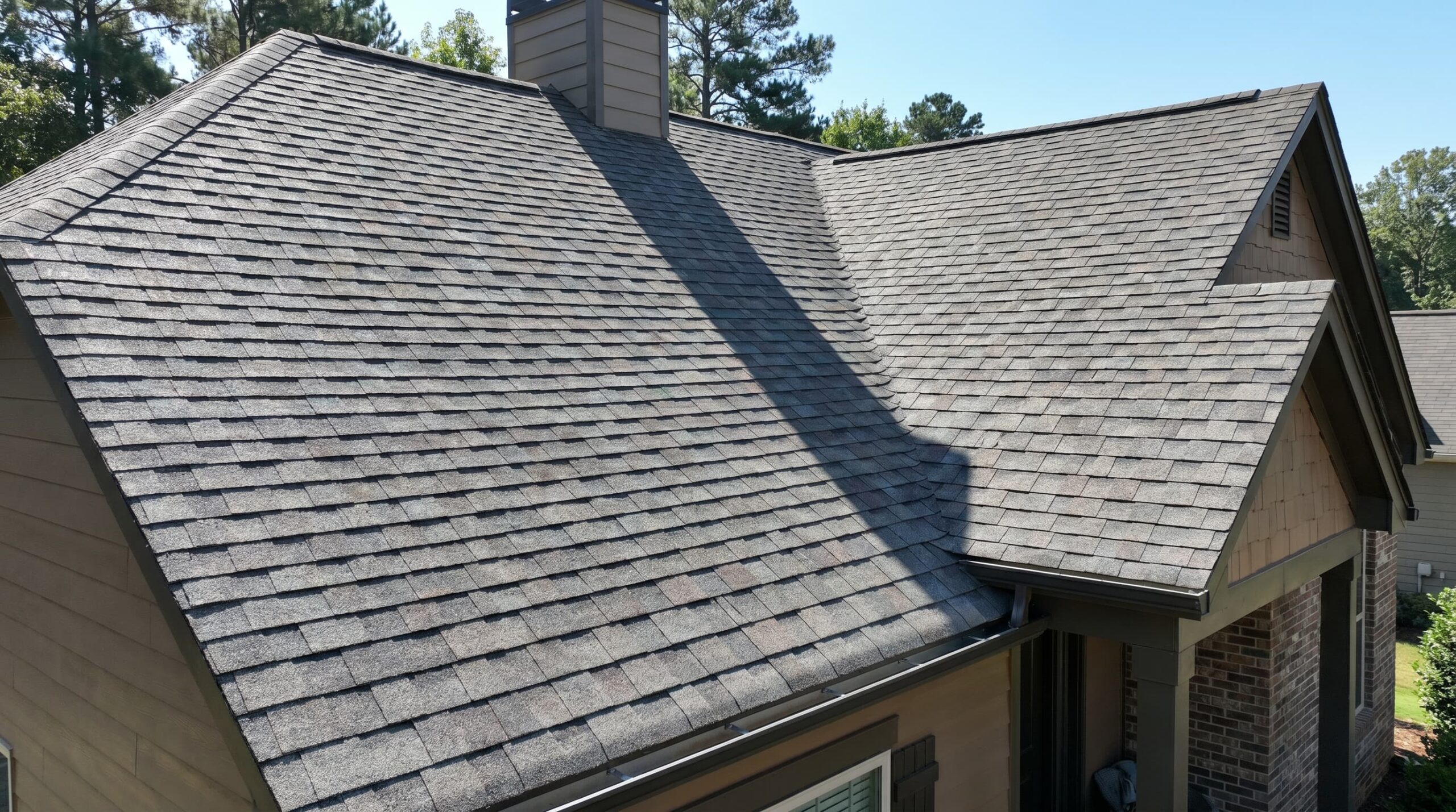 Asphalt shingles installed on a residential roof showing texture, layering, and material detail