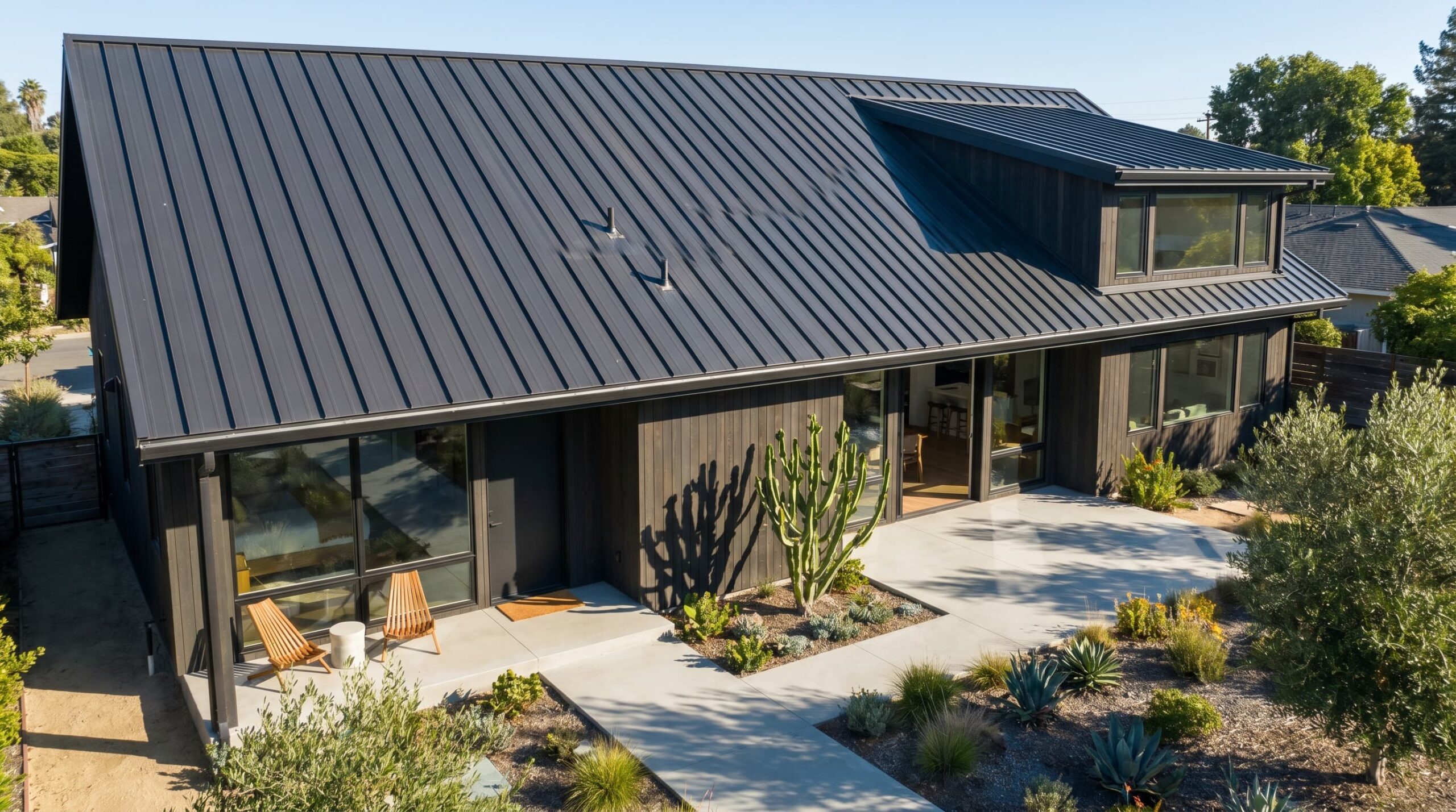 Standing seam metal roofing installed on a residential home with clean vertical panels and a reflective surface