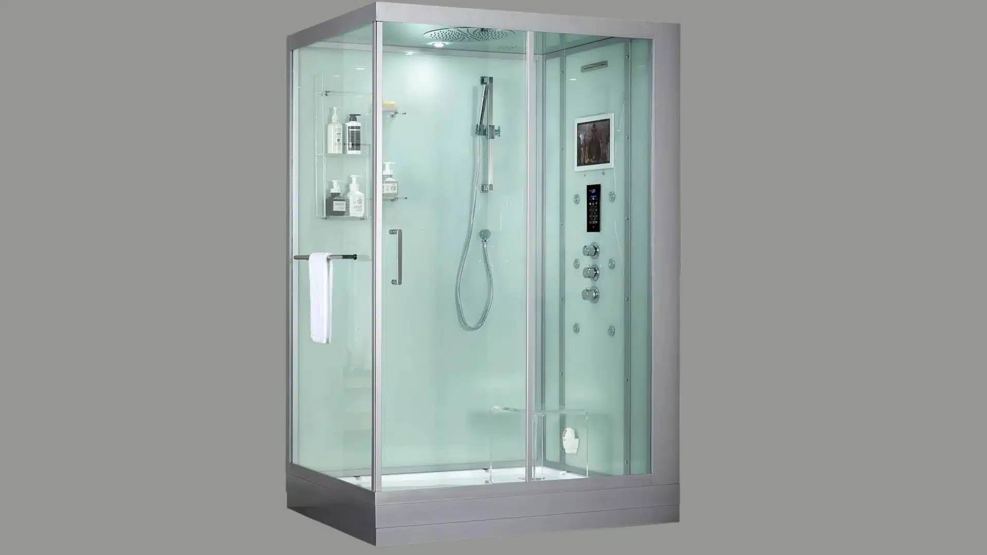 Glass-enclosed steam shower cabin with built-in controls, overhead shower, shelving, seating, and integrated entertainment display.
