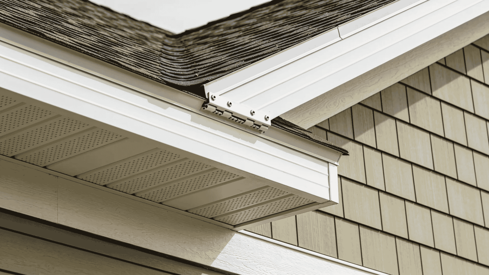 Installing final vinyl siding panel under soffit trim