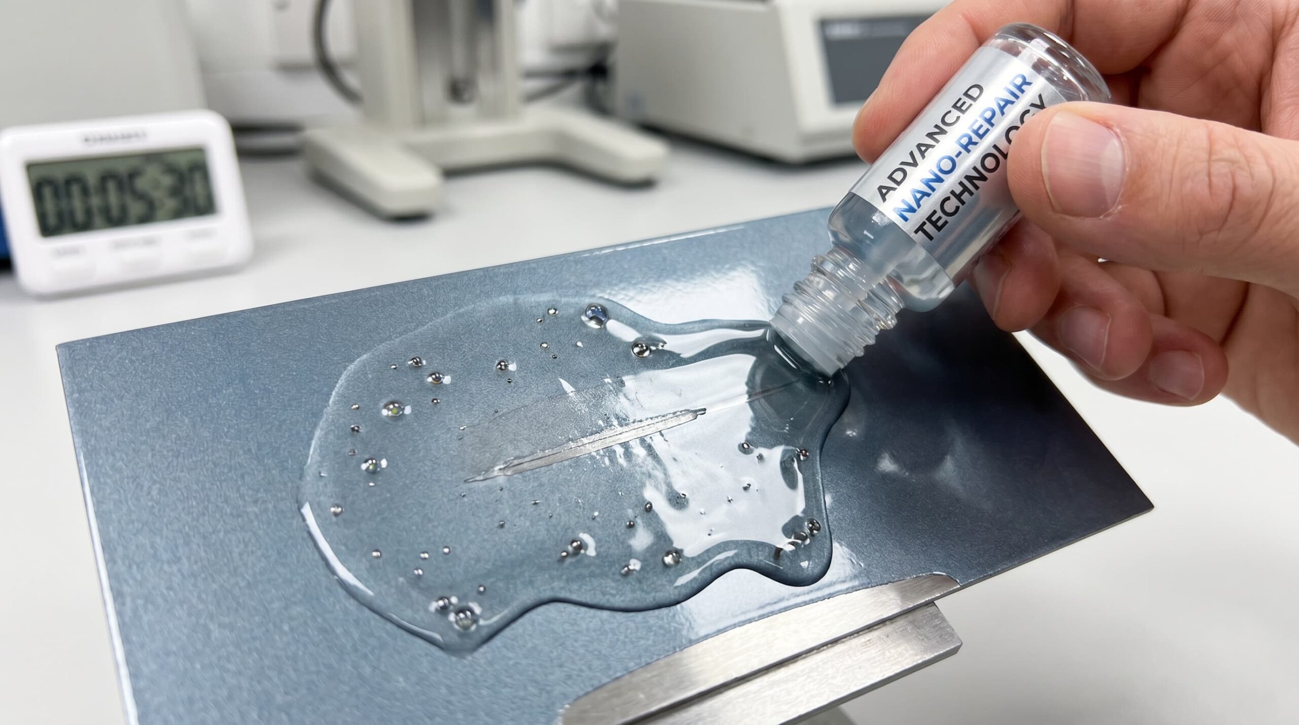 An image of self-healing paint being applied to a surface, showing a scratch being repaired over time.